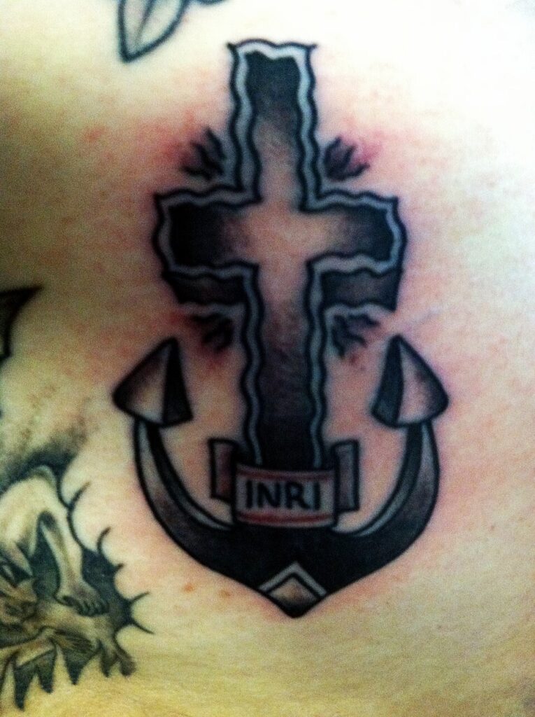 Cross and anchor tattoo with INRI banner