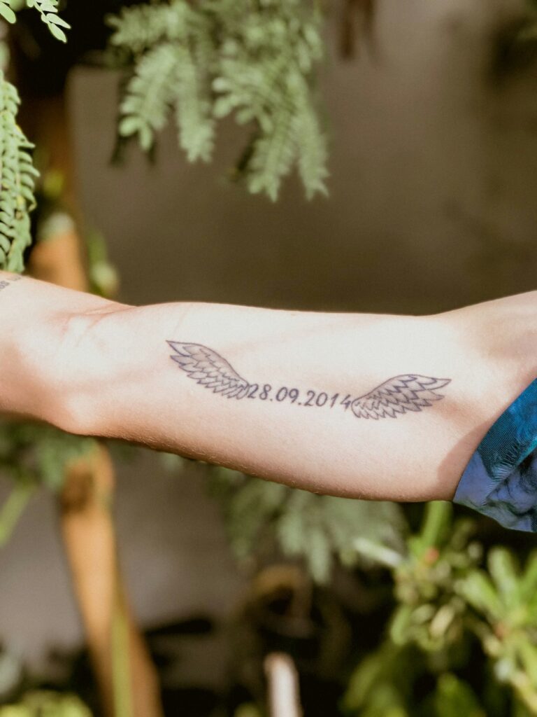Small Wing With a Date on the Forearm
