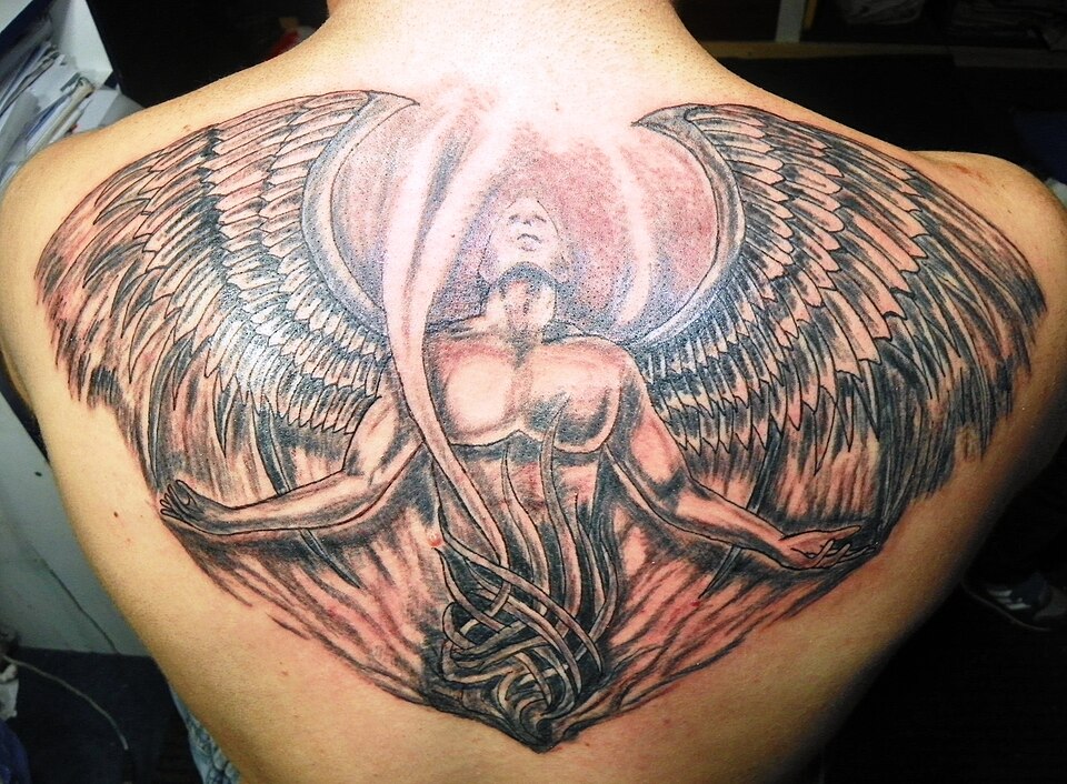 Angel with spread wings tattoo on a man's upper back