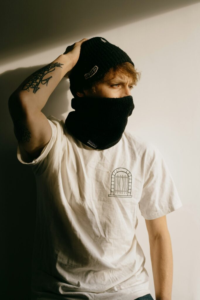 Man in a beanie with a tattooed arm sleeve