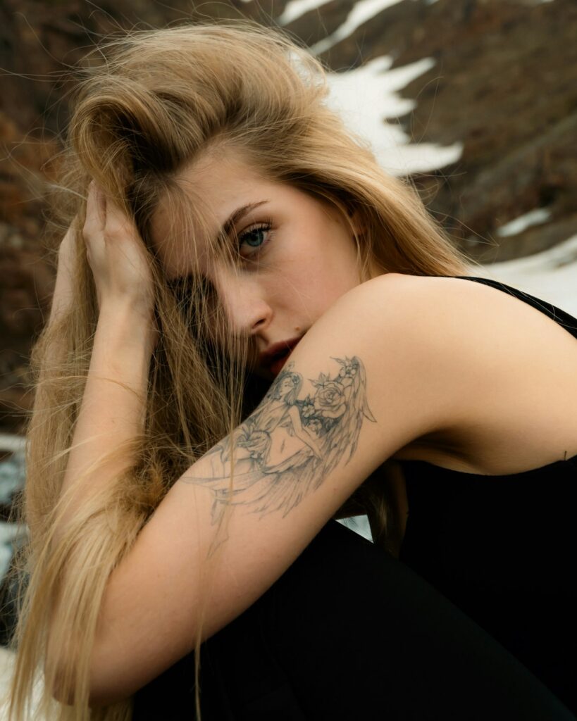 Woman sitting with a tattoo on her arm