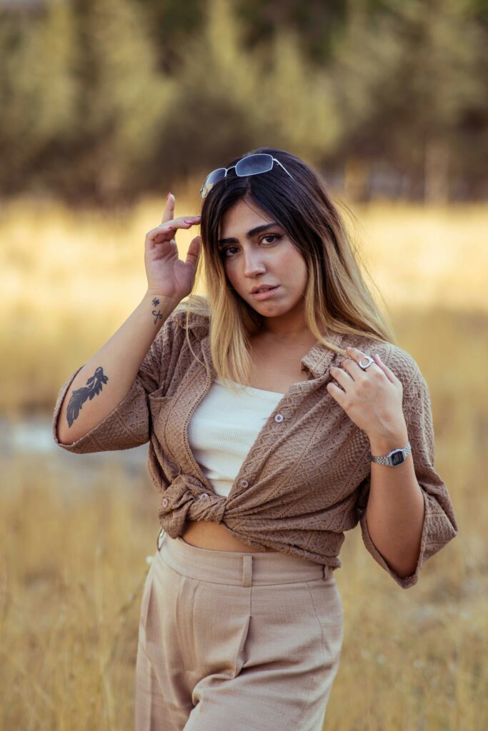 Arm tattoos for women: young woman in sunglasses with arm tattoos