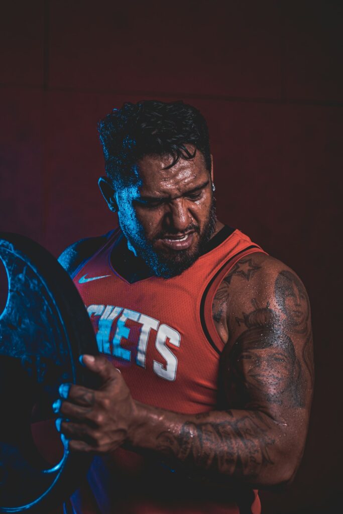 Athlete with a black and grey arm sleeve tattoo