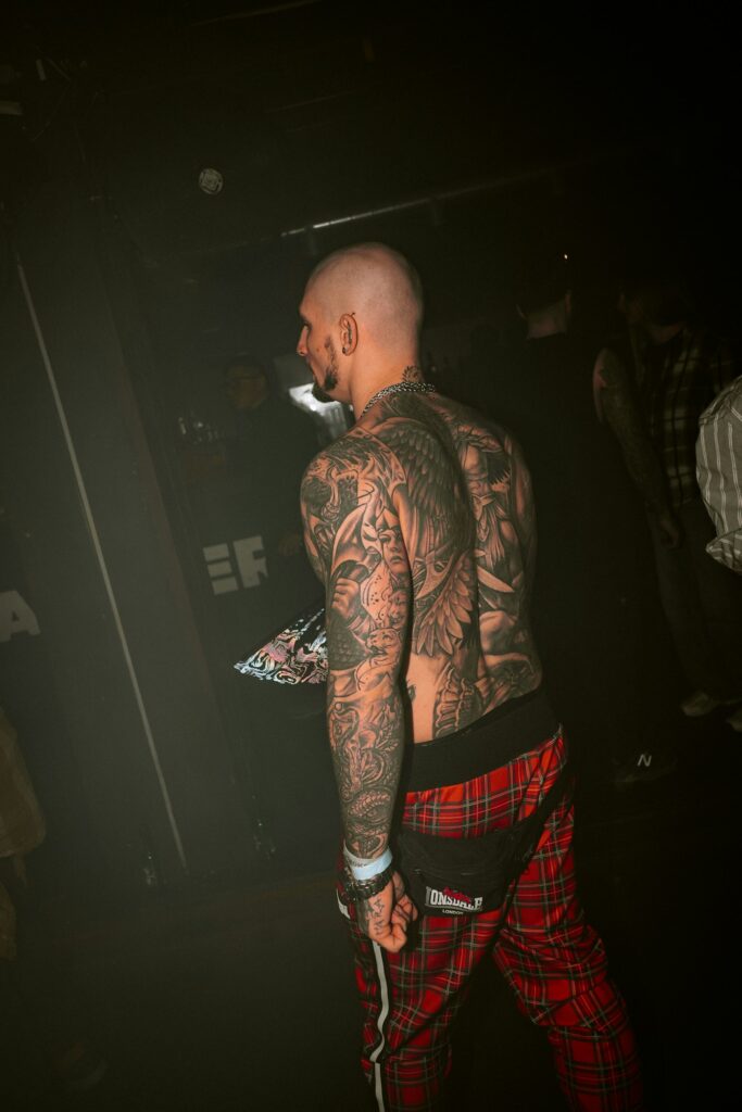 Man with detailed tattoos covering his back and arms