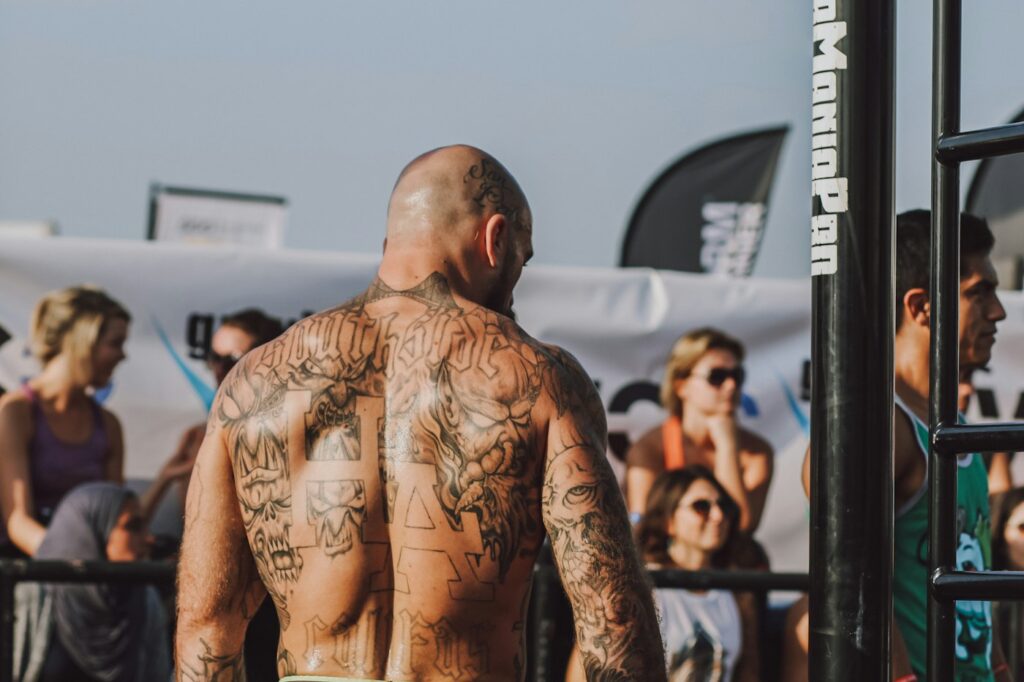 Man in black shorts showing his back tattoo