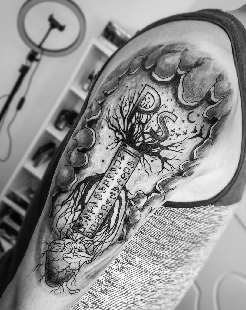 Close up of a detailed black and grey sleeve tattoo