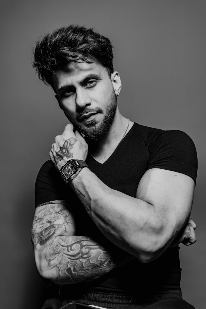 Black and grey sleeve tattoo on a man posing