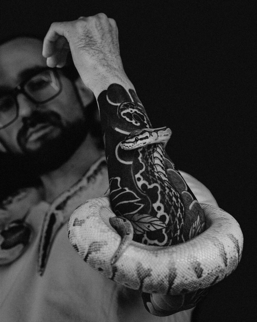 Black snake tattoo on the arm
