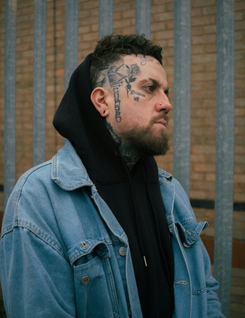 Blackwork tattoos on a man's face and neck