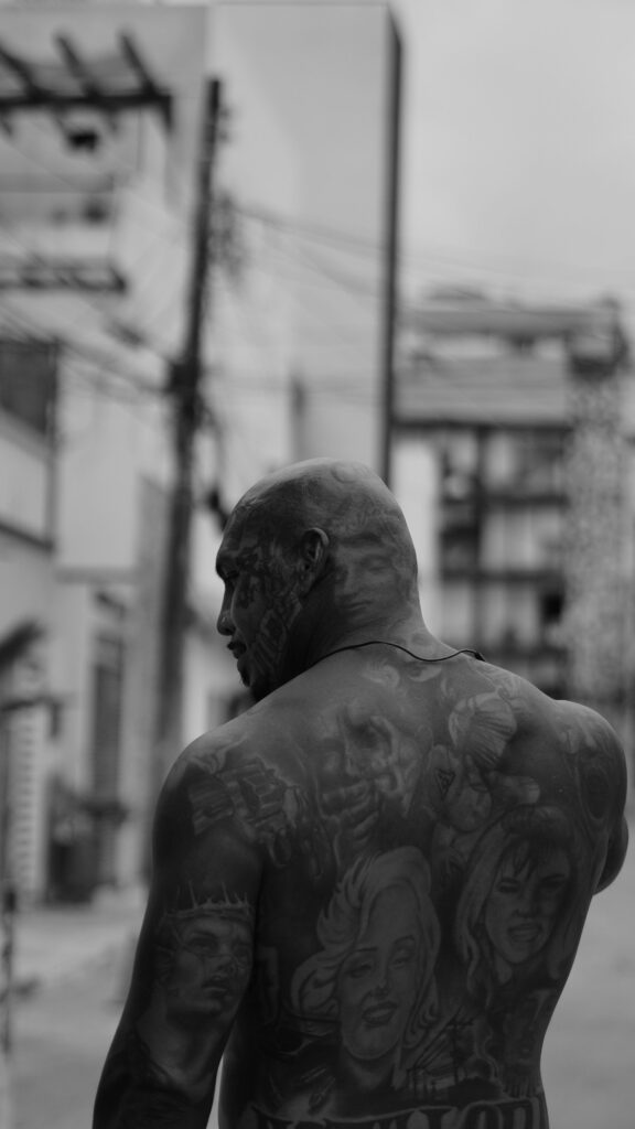 Blackwork tattoo: man with a heavily blacked out back and neck