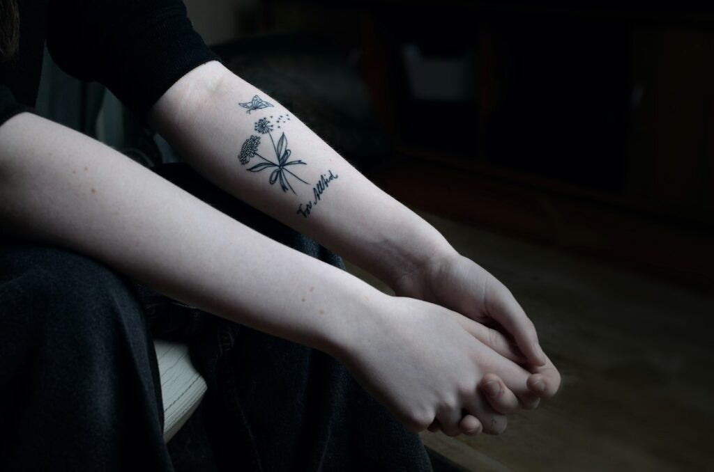 Forearm tattoos for women: botanical flower on the inner forearm