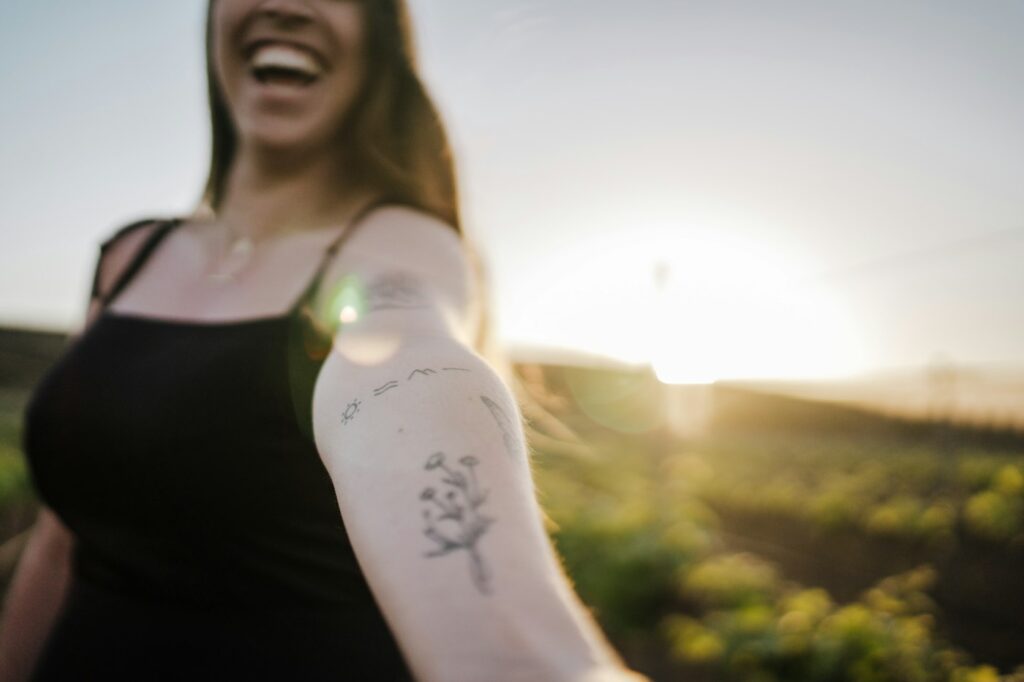 Arm tattoos for women: fine line botanical on the upper arm