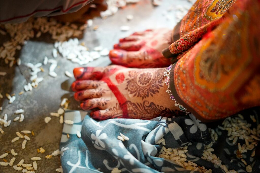 Bridal henna on the feet with red painted edges