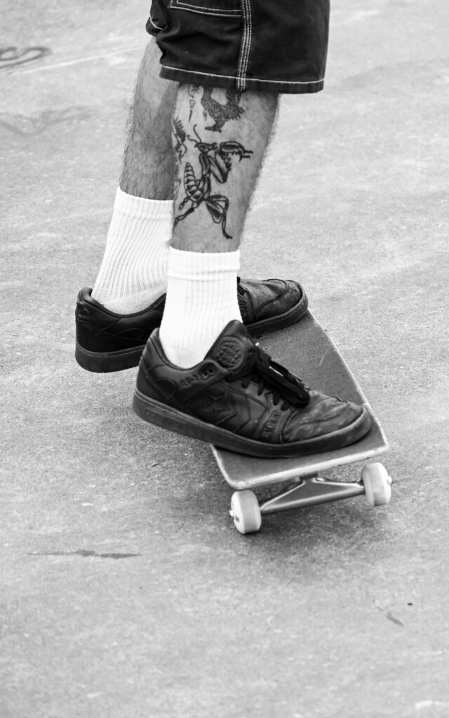 Skateboarder with a calf tattoo