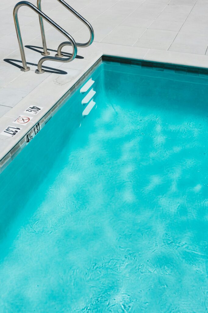 Chlorinated swimming pool with a metal ladder