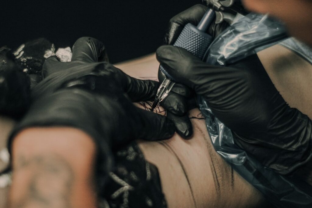 Close up of an artist shading a tattoo with a rotary machine