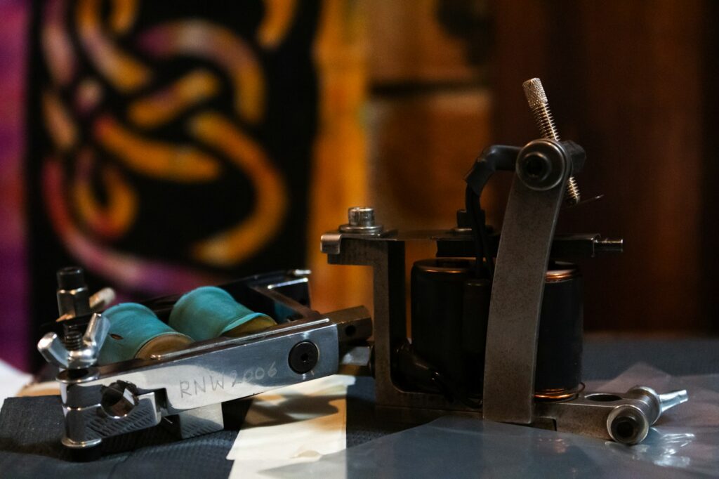 Traditional coil tattoo machine on a workbench