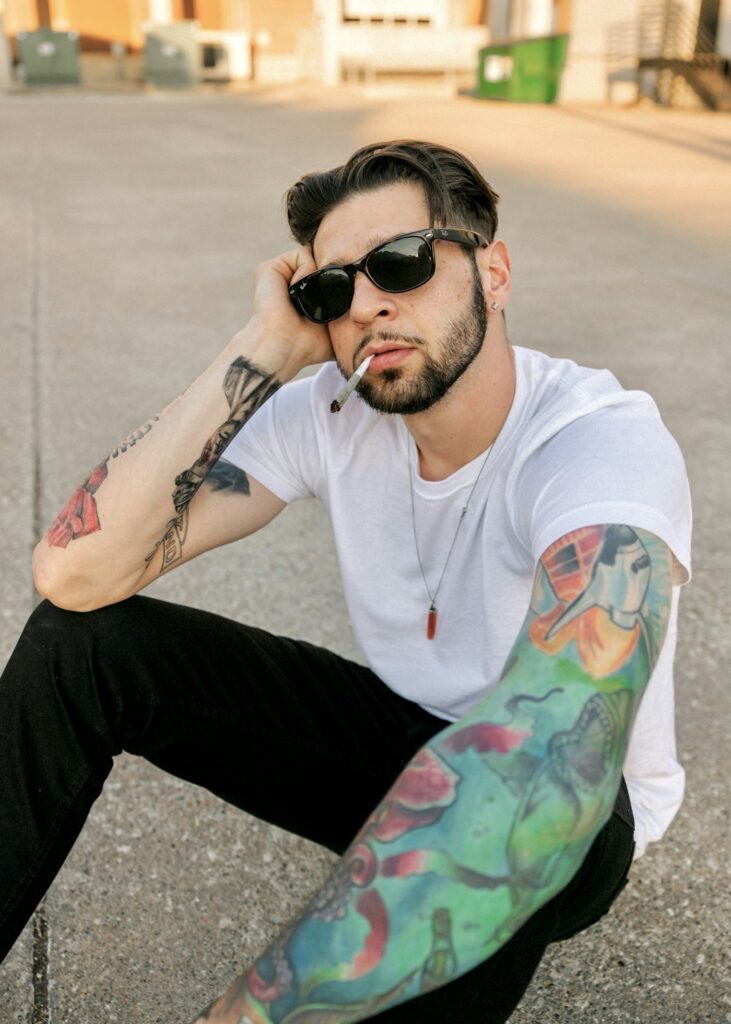Full color arm sleeve tattoo on a man in sunglasses