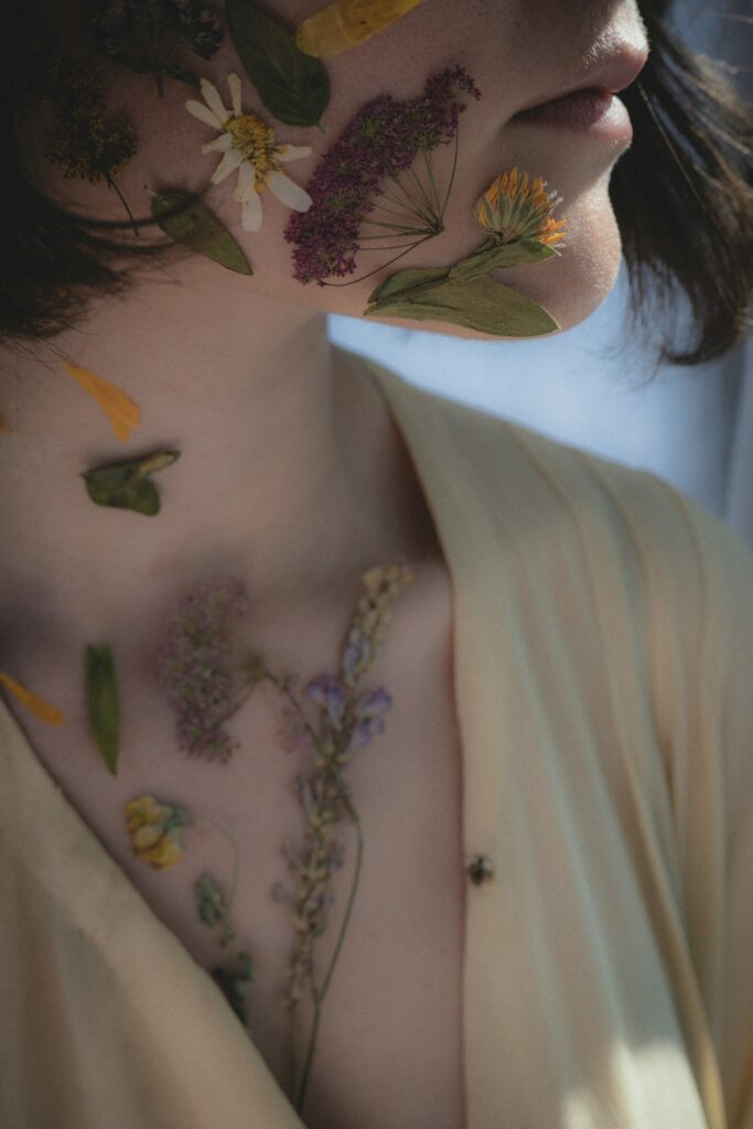 Color botanical flower chest tattoo on a woman