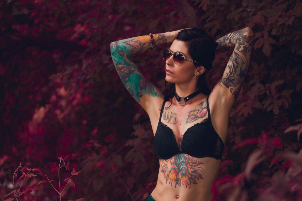 Color chest and sternum tattoos on a woman with arm sleeves
