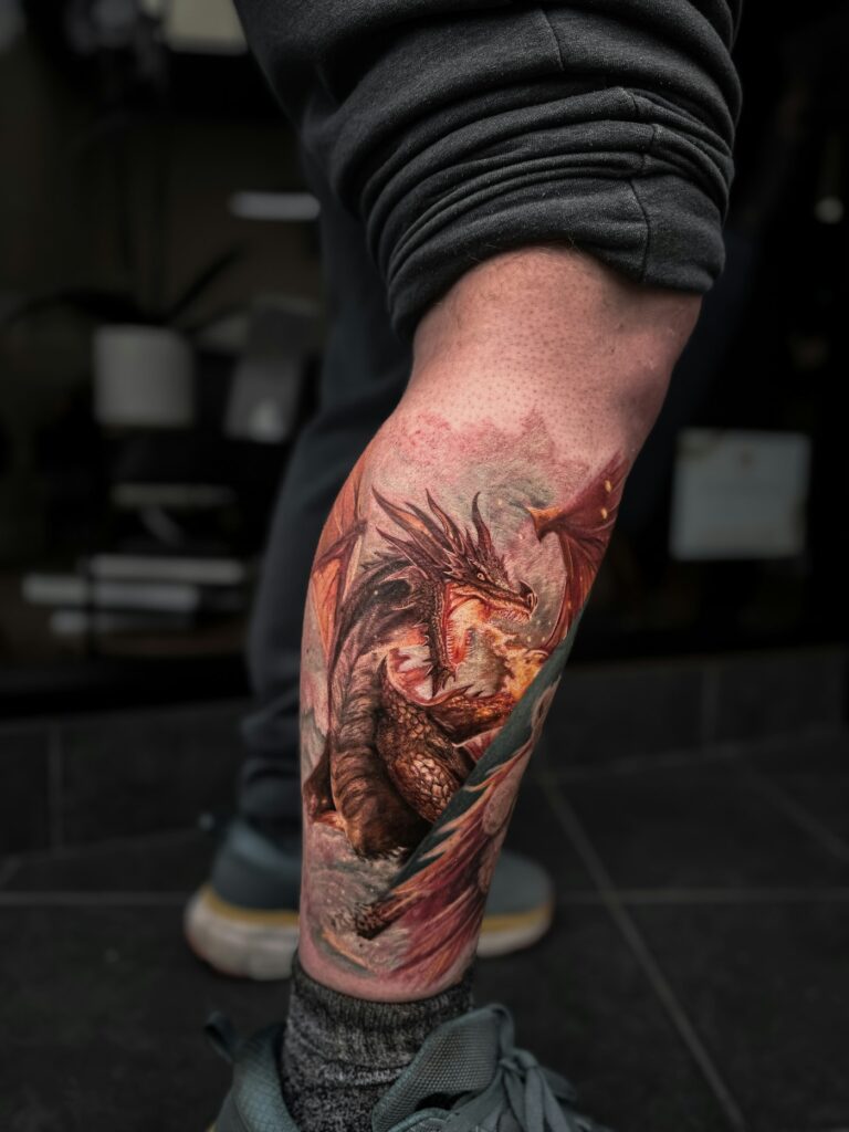 Color dragon tattoo on a man's calf