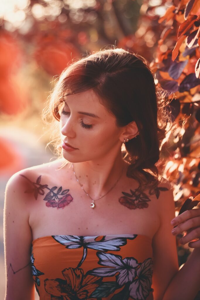 Color flower tattoos on a woman's upper chest
