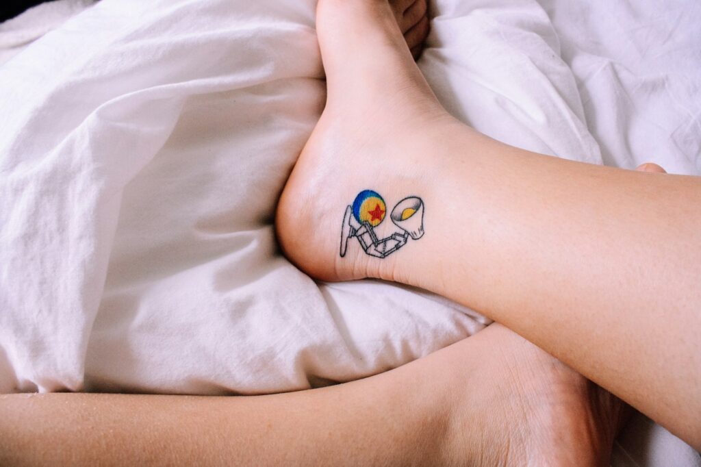 Colorful heart tattoo on the side of the foot