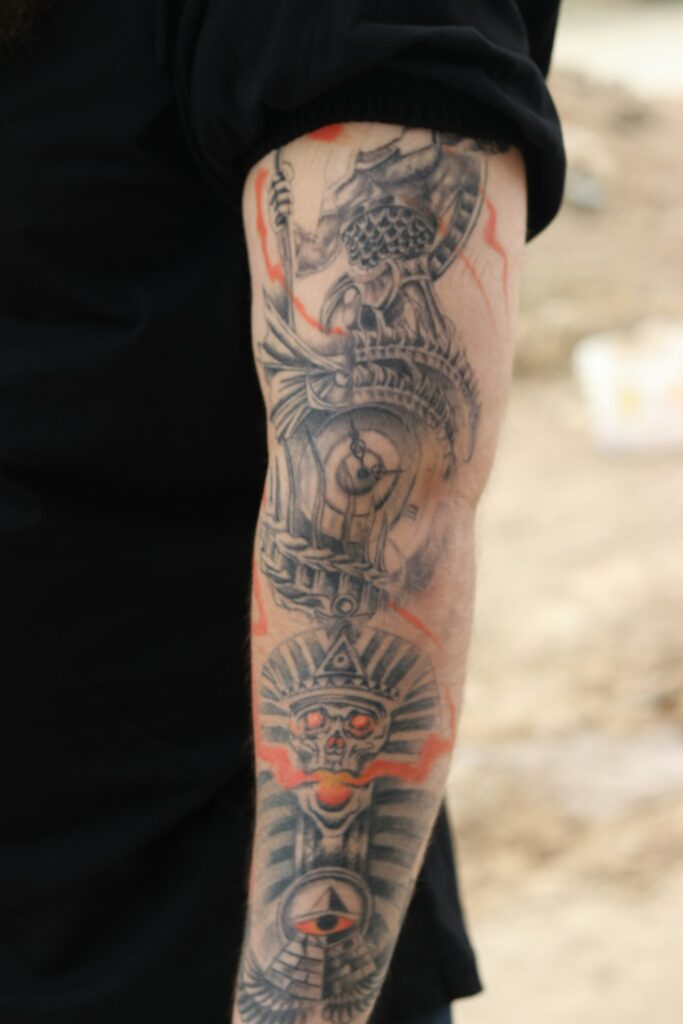 Full sleeve tattoo with orange color accents