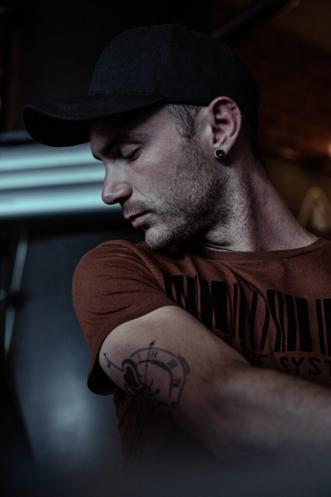 Compass tattoo on a man's upper arm below the shoulder