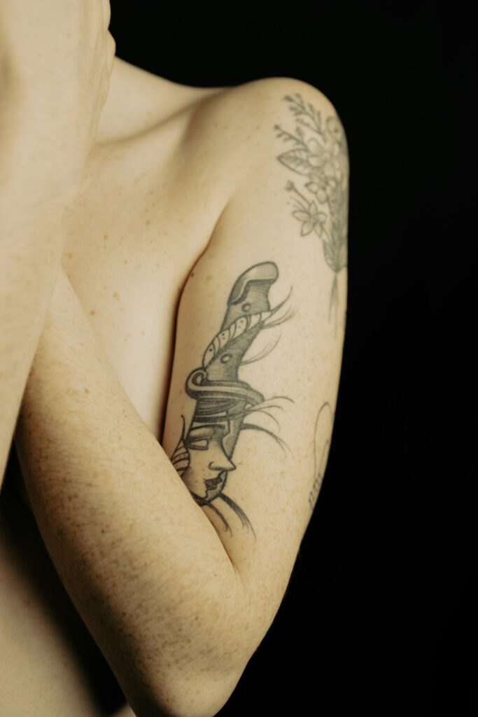 Dagger tattoo on the upper arm toward the shoulder