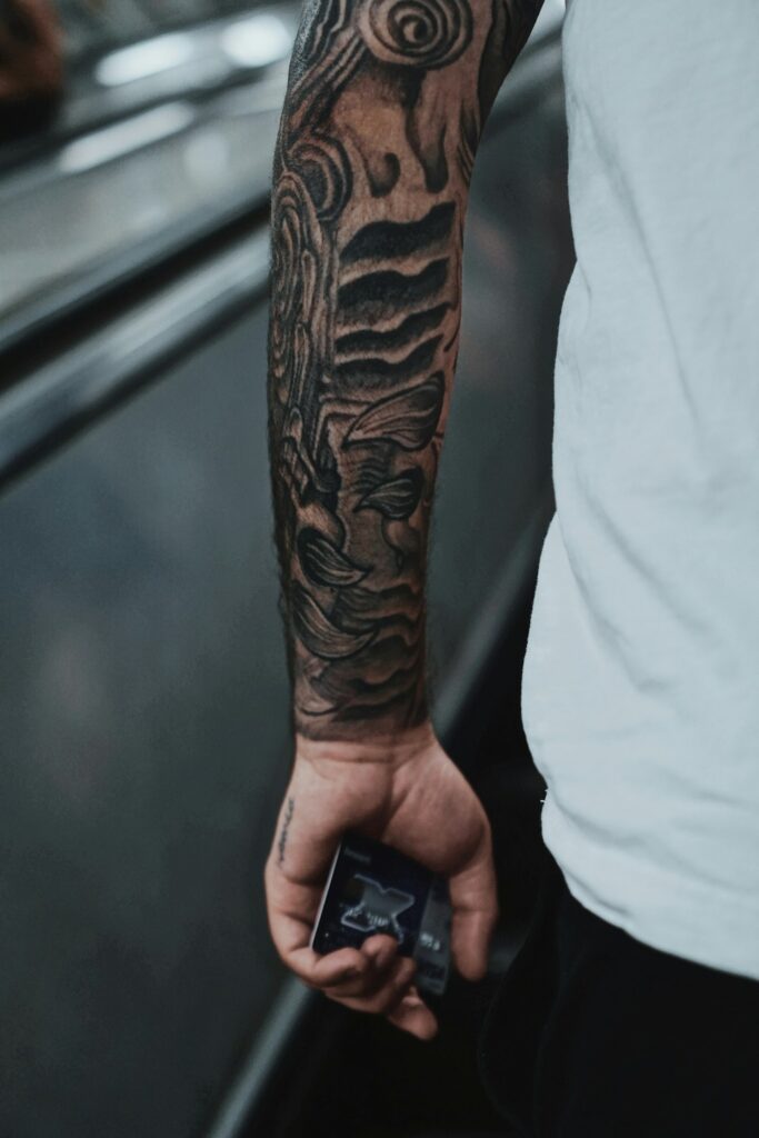 Dark full sleeve tattoo on a man's arm