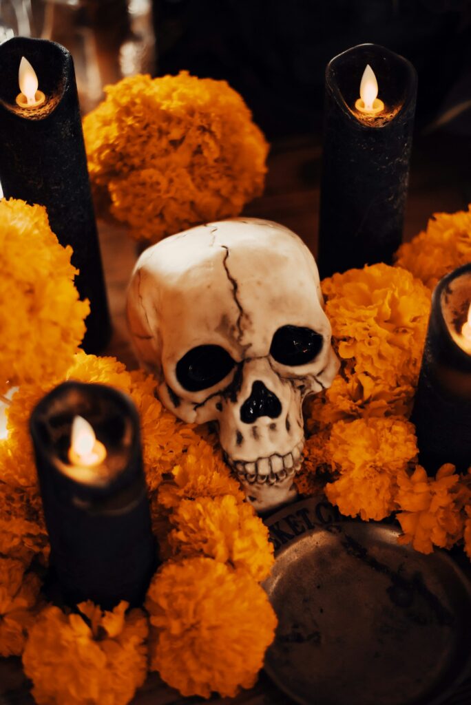 Day of the Dead skull surrounded by marigolds and candles