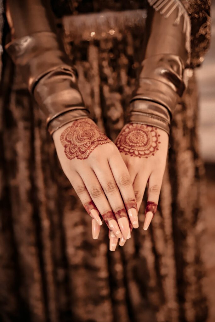 Deep reddish brown henna stain on both hands