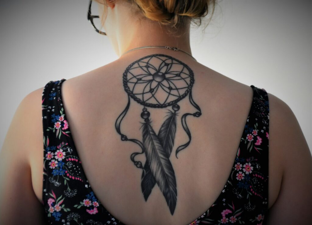 Dreamcatcher tattoo on a woman's back