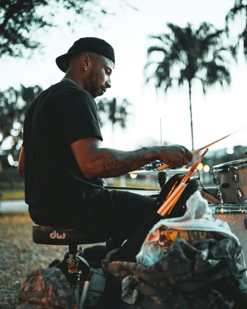 Drummer with healed black tattoos on both arms