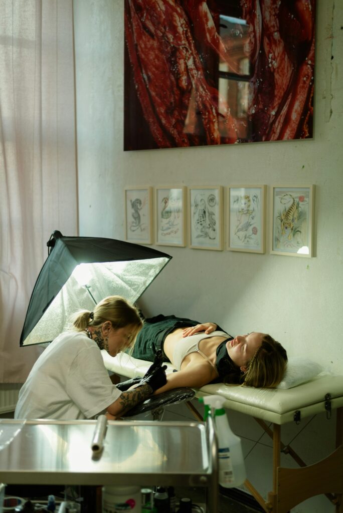 First tattoo tips: client getting a tattoo in a bright, clean studio