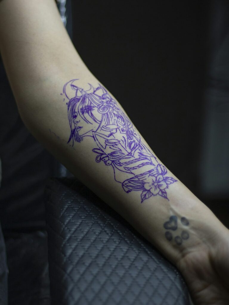 Floral tattoo stencil on the forearm before tattooing