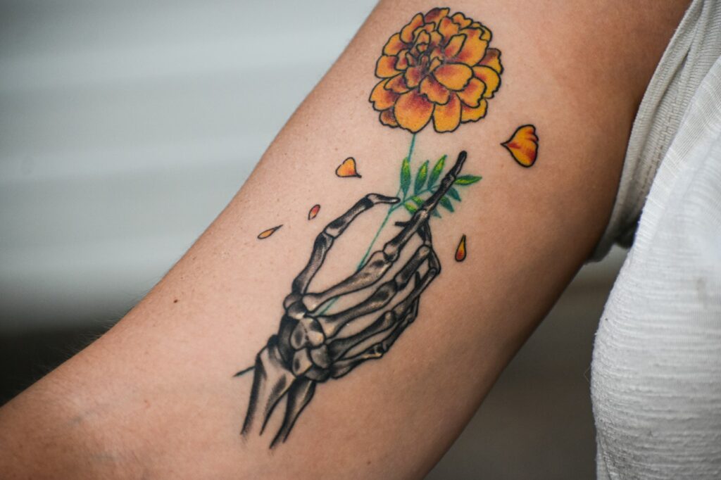 Flower tattoo with roses on the arm