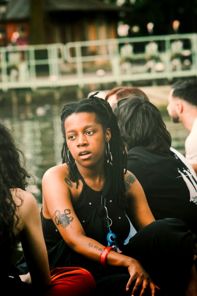 Woman with dreadlocks and forearm tattoos