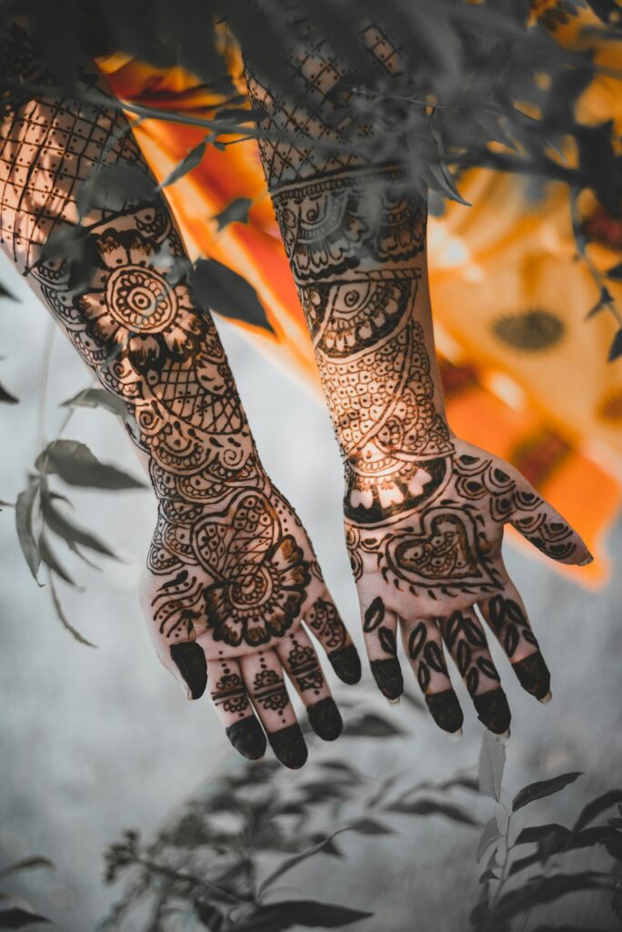 Dark henna covering both hands and forearms
