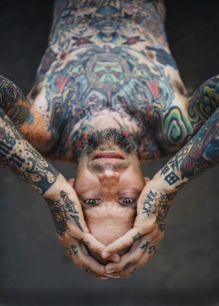 Fully tattooed hands with color traditional designs