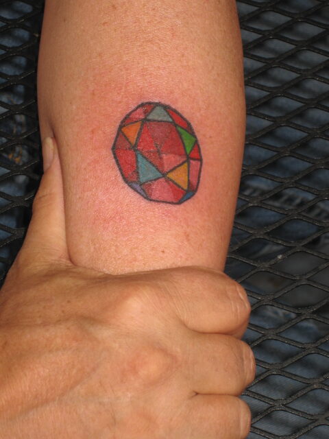 Colorful geometric polyhedron tattoo