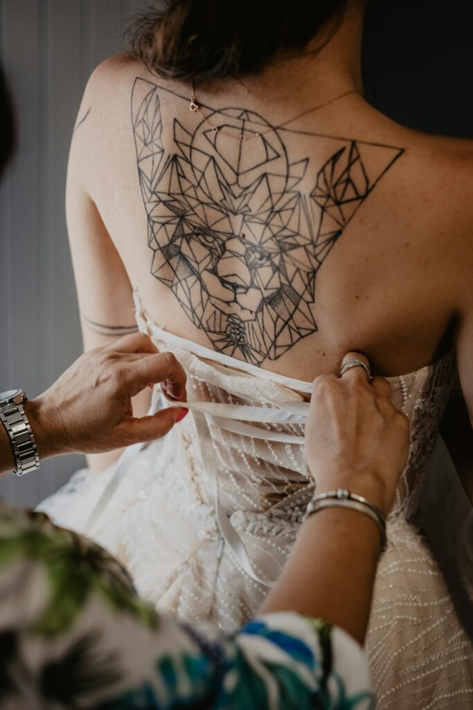 Geometric lion tattoo on a bride's upper back