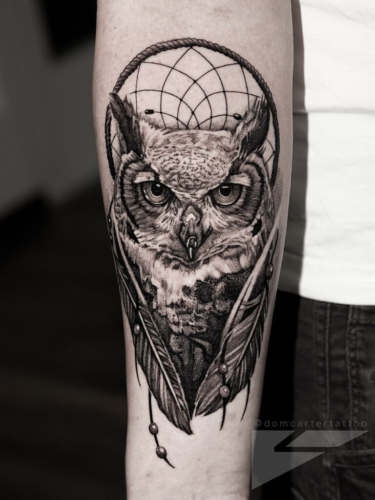 Realistic great horned owl tattoo on the forearm