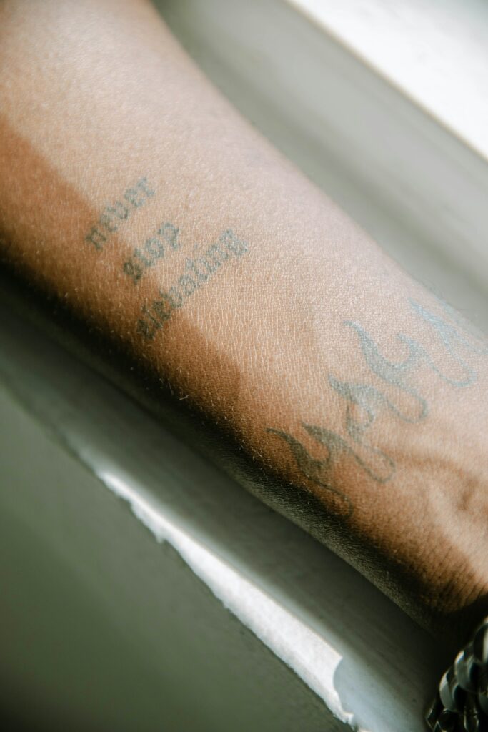 Healed forearm tattoo with soft, slightly spread lines