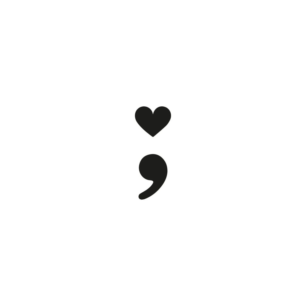 Semicolon tattoo design with a heart in place of the dot