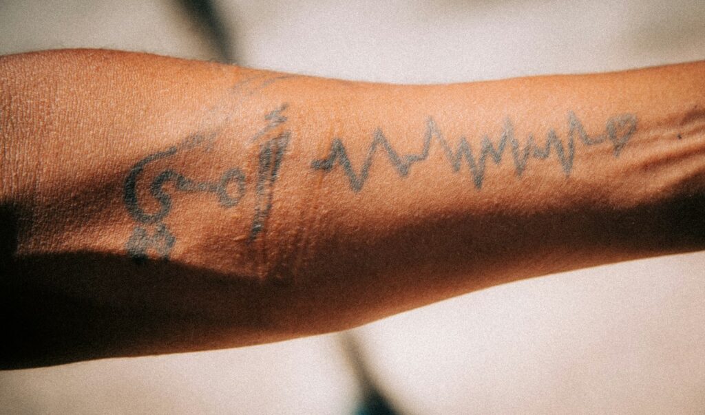 Heartbeat line tattoo across the forearm
