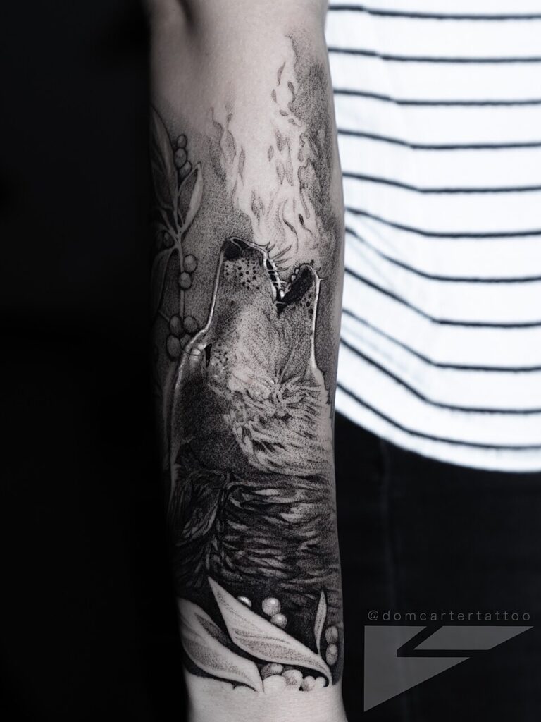 Howling wolf in a forest, black and grey forearm sleeve tattoo