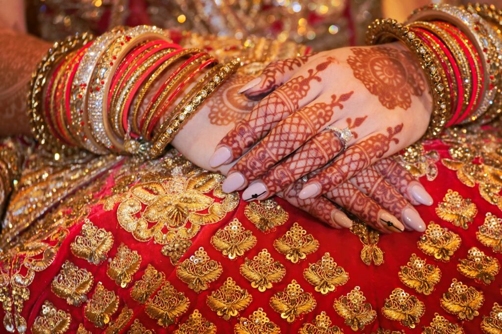 Indian bridal henna with red and gold bangles