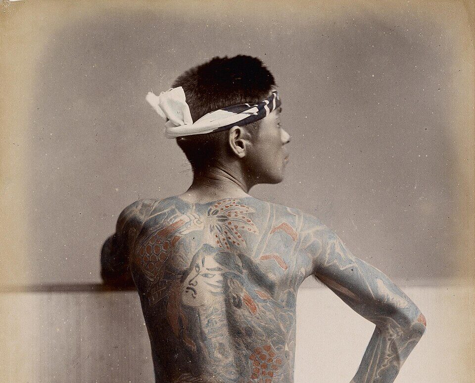 Hand colored 1890s photograph of a tattooed Japanese man